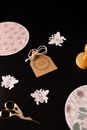 Composition of decorative applique works and scissors on black background