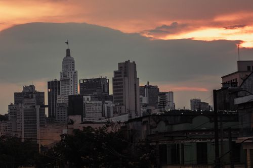 Free Contemporary city with skyscrapers and modern buildings under colorful cloudy sky at sundown Stock Photo