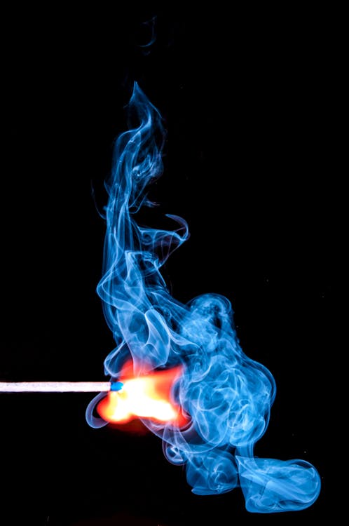 Free Lighted Match With Smoke on Black Background Stock Photo