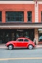 Red retro car on road in city