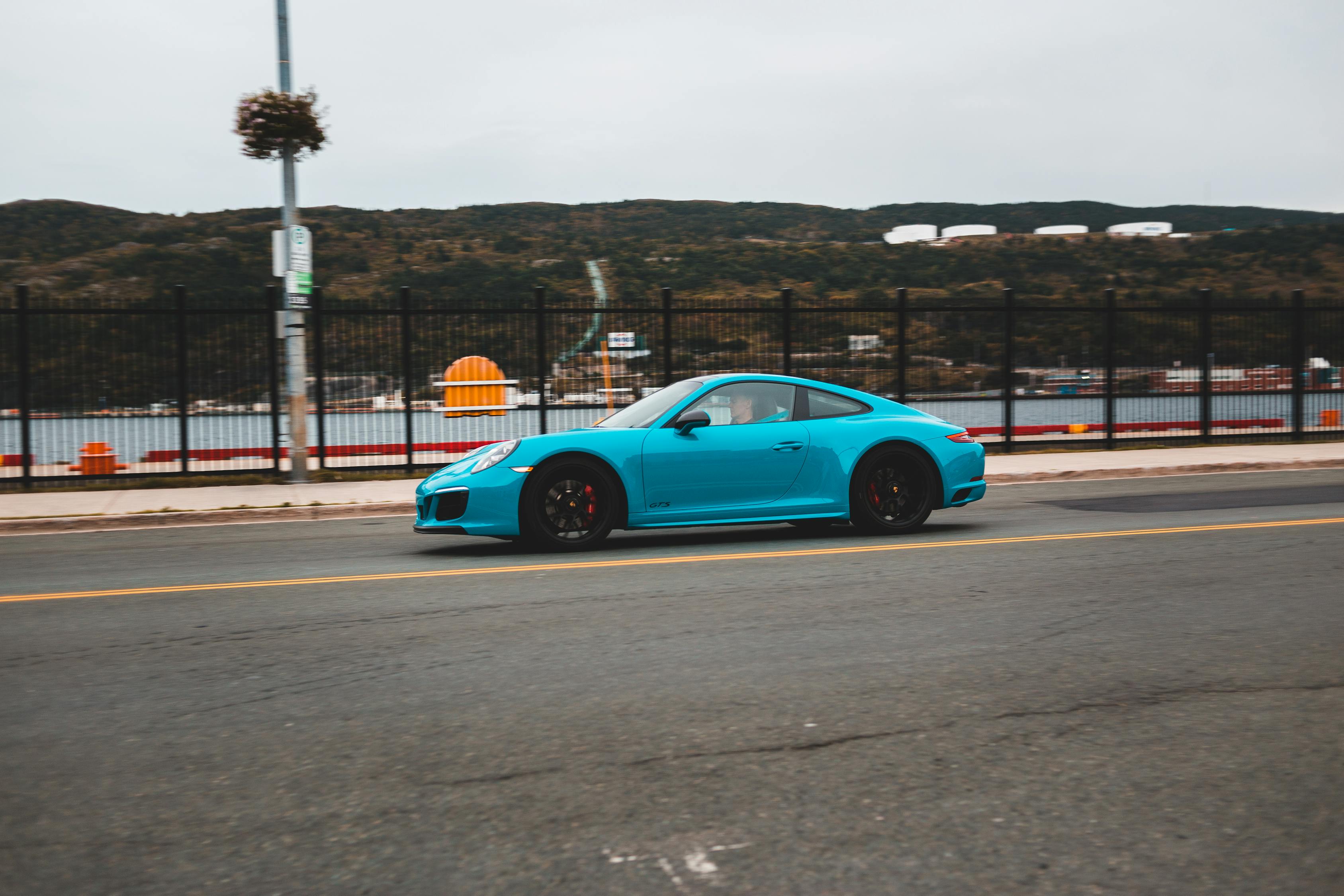 Modern car riding along quay · Free Stock Photo