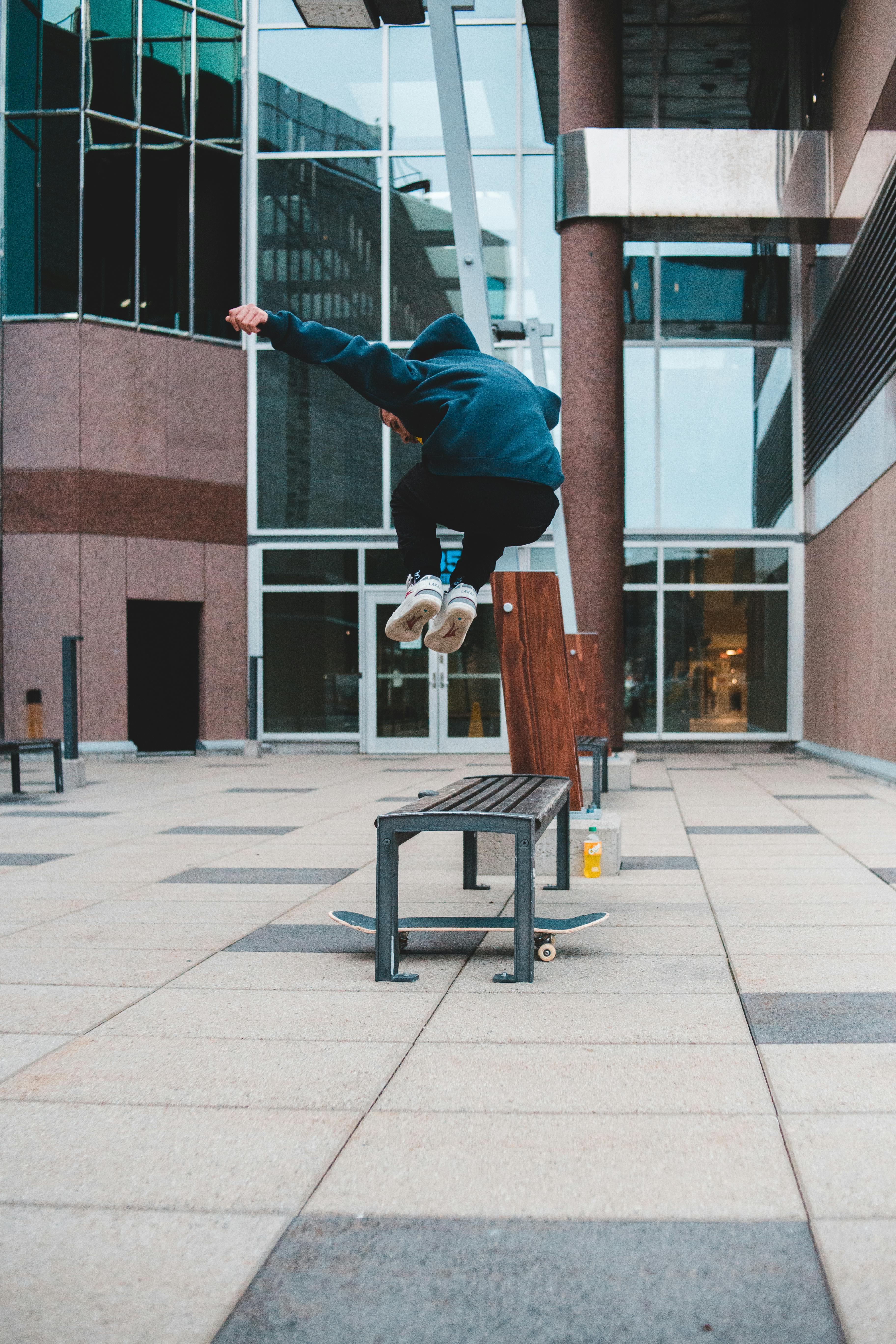 unrecognizable sportsman jumping over bench