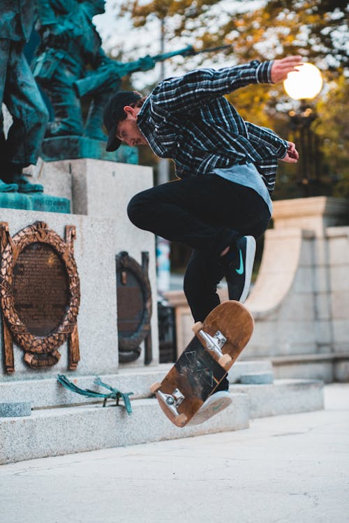 Skateboarder jumping on skateboard in street