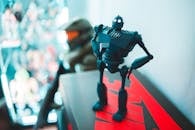 Plastic toy robot on bright shelf at home