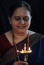 Smiling Woman in Black and Red Shirt With Gold Necklace