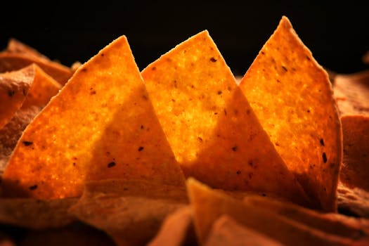 Delicious crispy corn chips perfectly lit, showcasing their golden texture and inviting appeal.