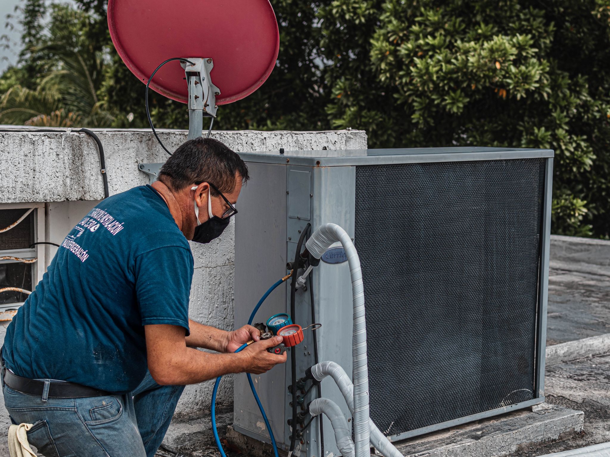 Technician servicing a heating and cooling unit