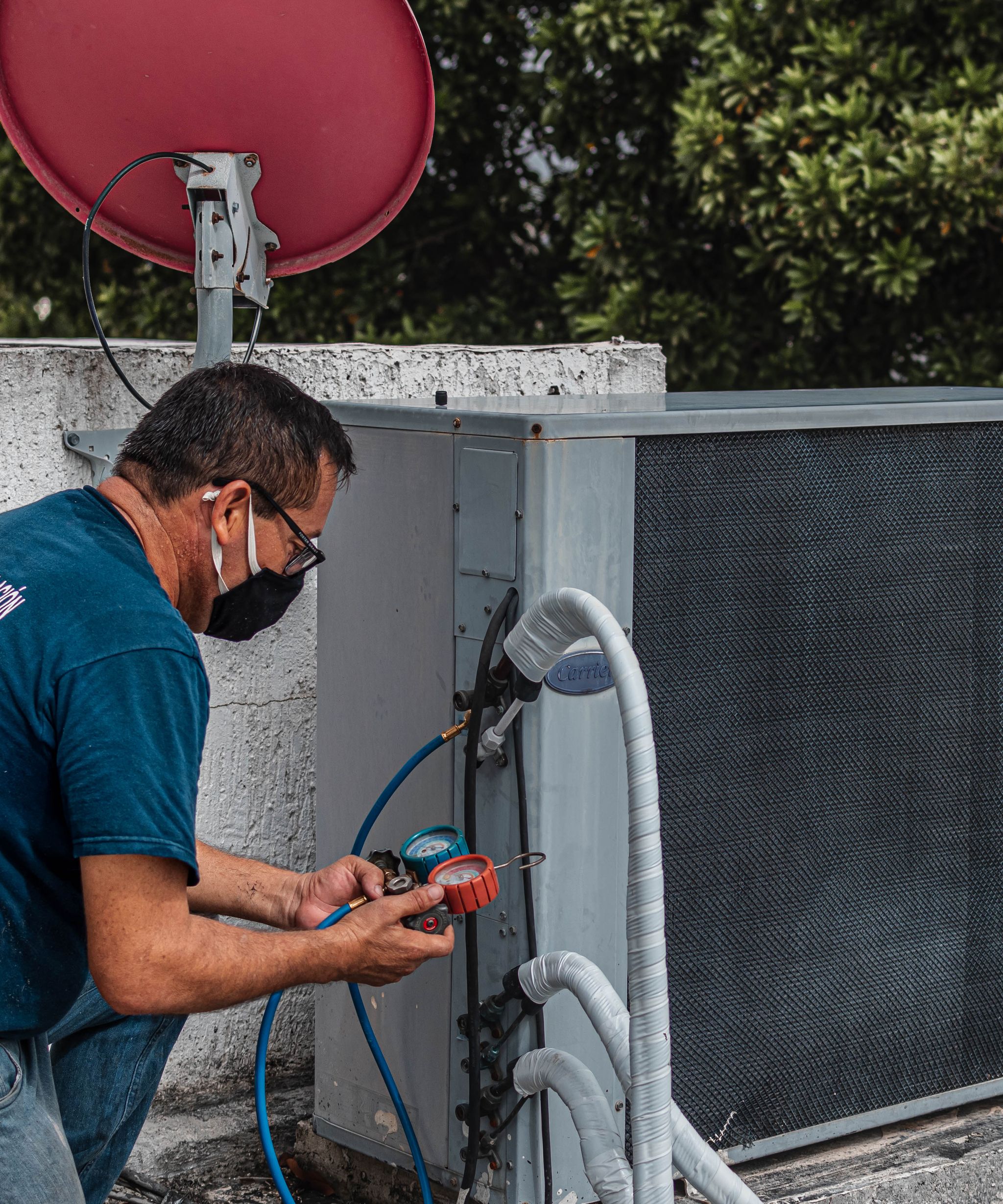 Technician servicing a heating and cooling unit