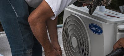 HVAC technician working on air conditioning — RV AC repair service