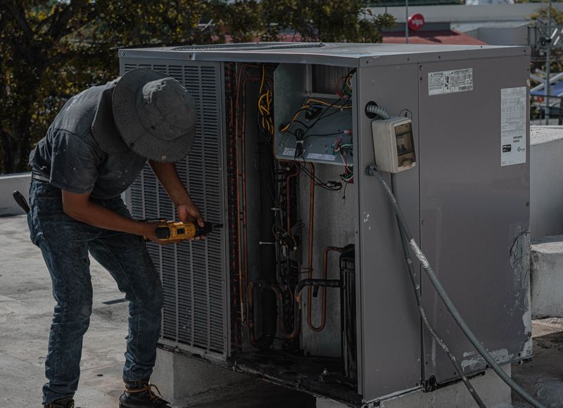 Technician repairing an air conditioning system