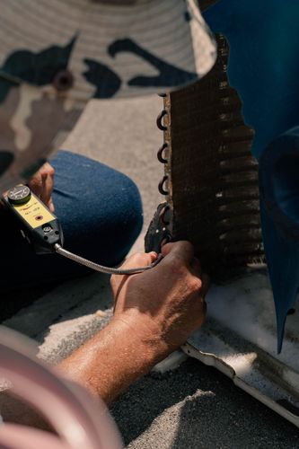 HVAC technician servicing an air conditioning unit