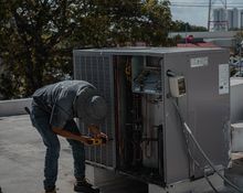 Technician servicing an air conditioning unit — photo by José Andrés Pacheco Cortes on Pexels