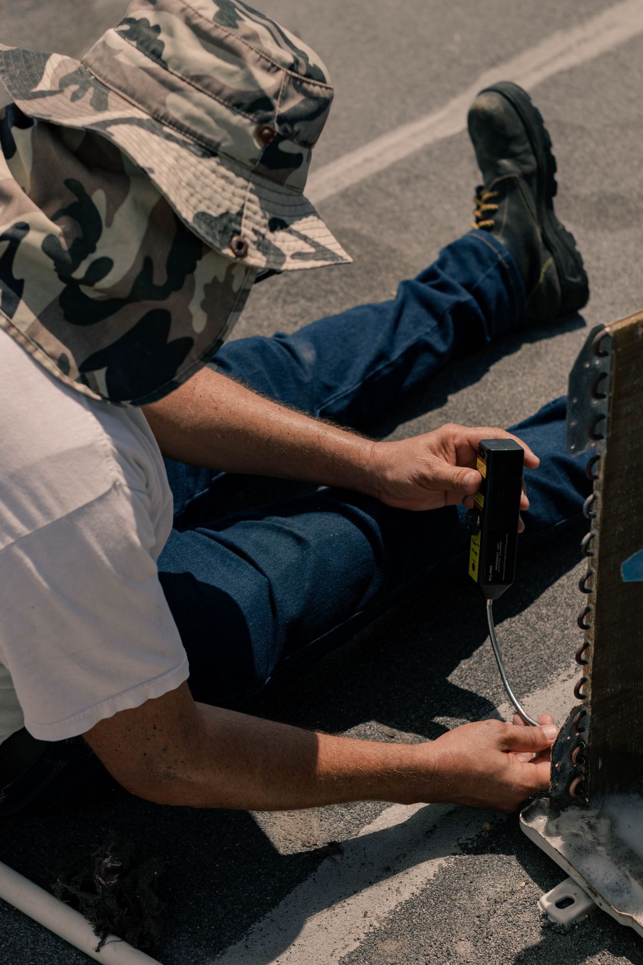 Technician servicing an air conditioning system; illustrative stock photo, not AAC staff or a company project