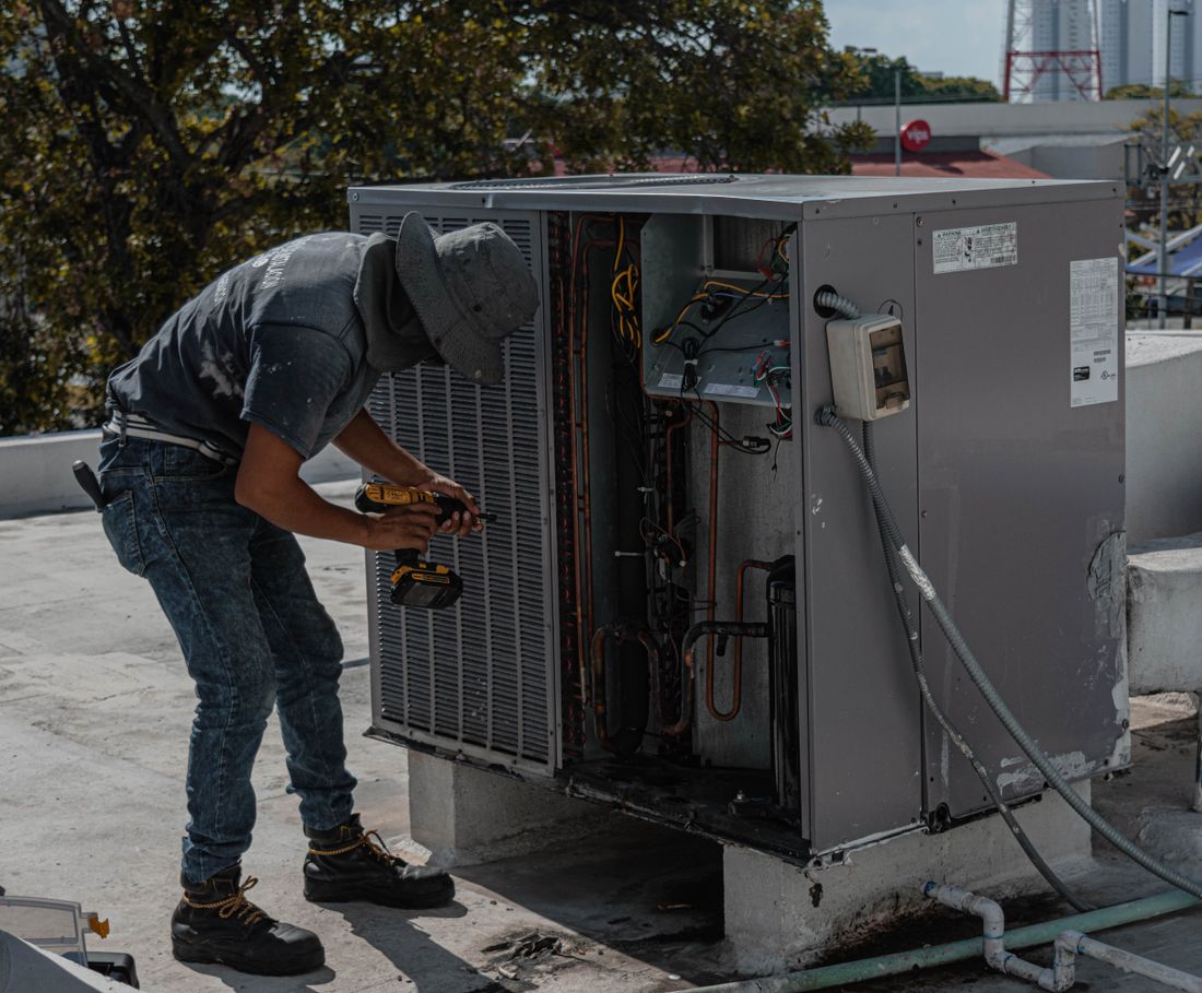 A Summit technician servicing a residential condenser unit