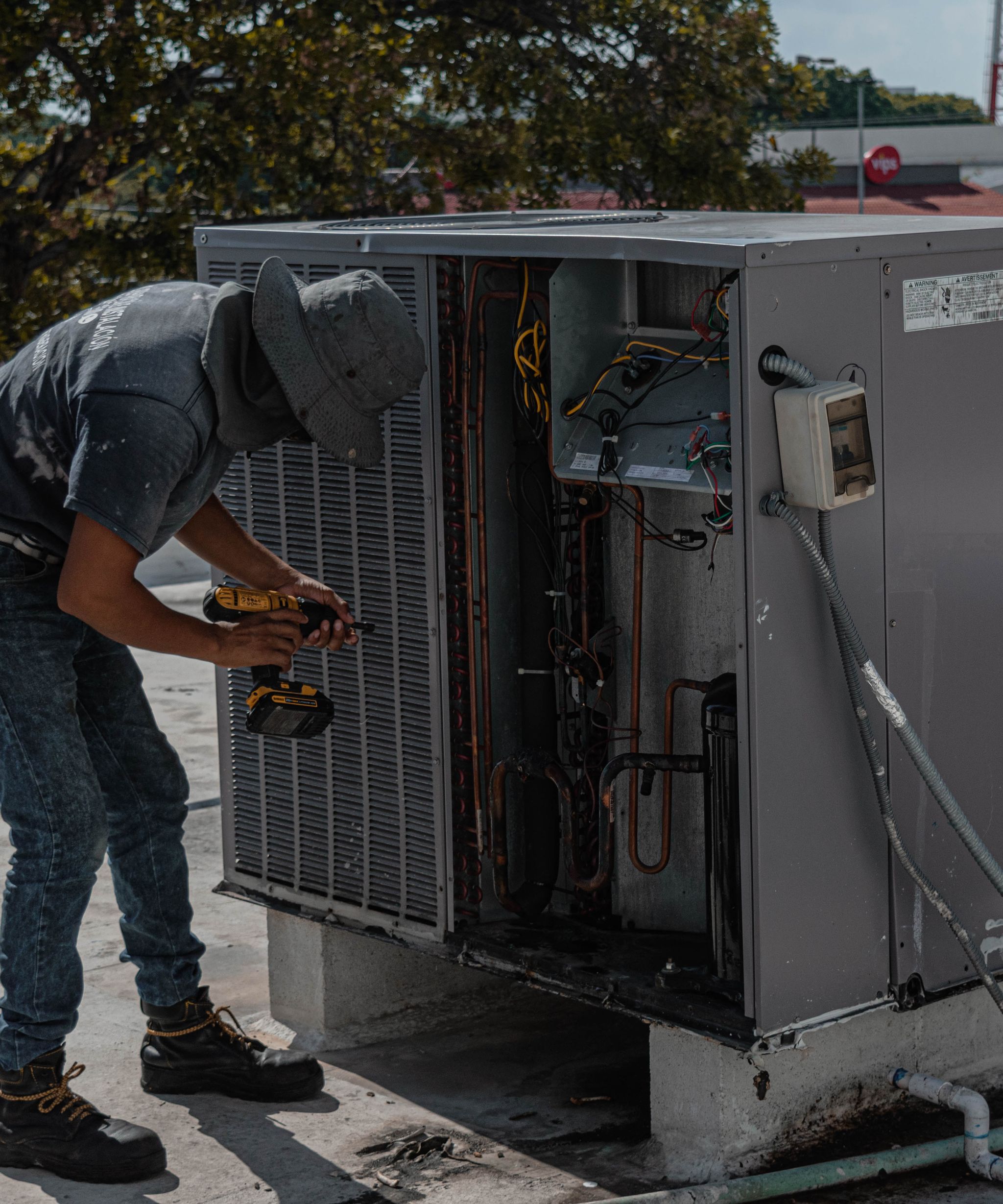 Technician servicing a heating and cooling unit