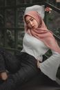 Woman in White Long Sleeves Wearing Pink Hijab Sitting Against Metal Railings