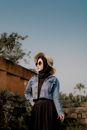 Woman in Blue Denim Jacket Wearing Sun Hat and Hijab