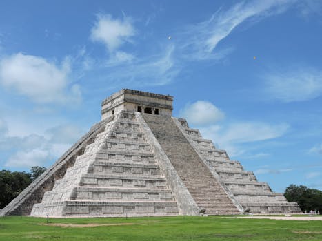 El Castillo pyramid at Chichen Itza in Mexico, showcasing ancient Maya architecture under a bright blue sky.