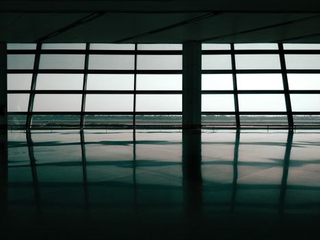 Spacious airport terminal window reflections create a geometric and architectural effect.
