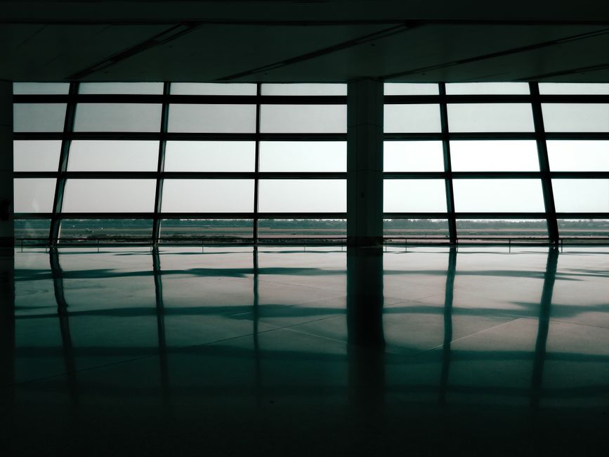 Spacious airport terminal window reflections create a geometric and architectural effect.