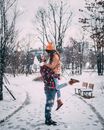 Woman in Red and White Plaid Shirt and Blue Denim Jeans Standing on Snow Covered Ground