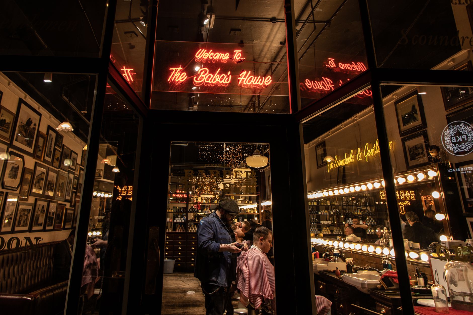 Modern Manchester barber shop with neon lights and warm ambiance, showcasing grooming.