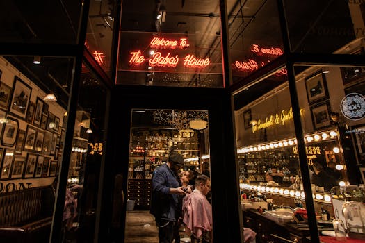 Modern Manchester barber shop with neon lights and warm ambiance, showcasing grooming.