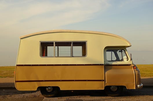 A classic campervan parked near a scenic coastal view in Medway, England.