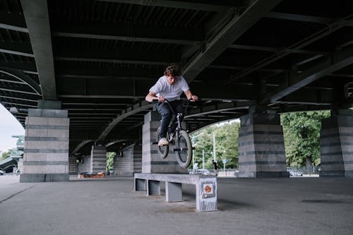 Man Riding a Bike on a Bench