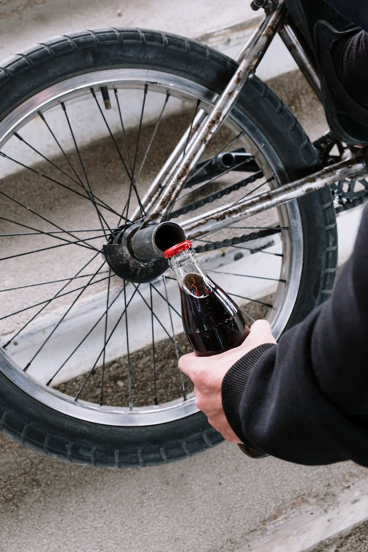 Person Opening A Bottle On A Step Nut