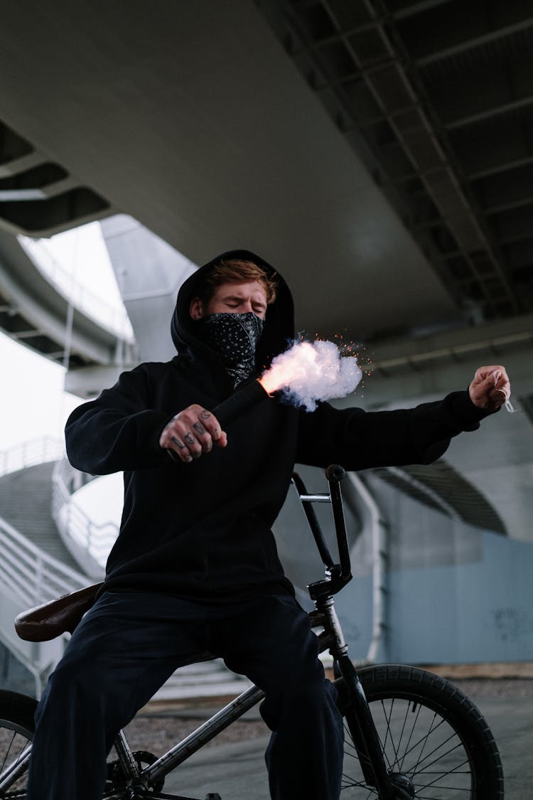 Man In Black Hoodie Sweater Holding A Firecracker