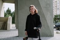 Woman in Black Long Sleeve Shirt Standing Beside Bicycle