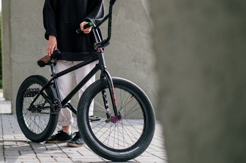 Free Person in Black Coat and Black Pants Riding Black Bicycle Stock Photo