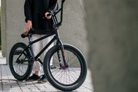 Person in Black Coat and Black Pants Riding Black Bicycle