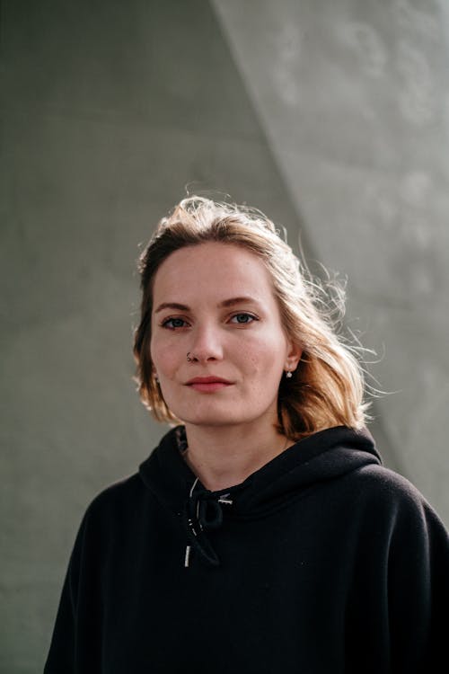 A Woman in Black Shirt Looking at the Camera