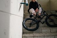 Person in Black Jacket Sitting on Stairs