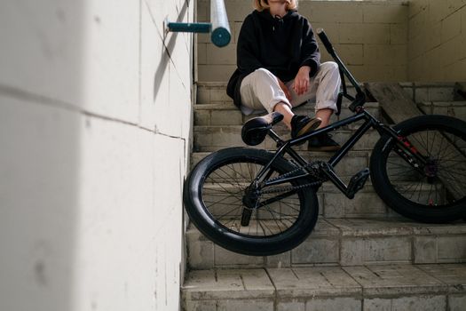 Person in Black Jacket Sitting on Stairs
