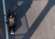 Person in Gray Jacket Riding Motorcycle