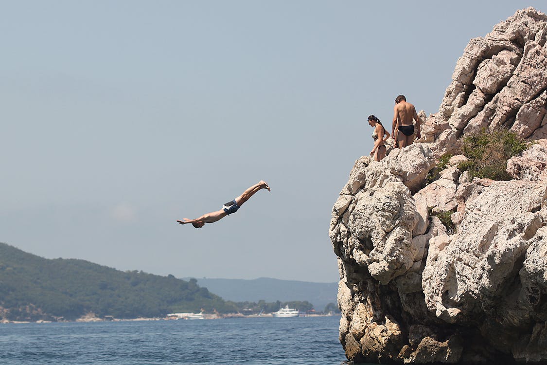 Free People Standing on the Cliff Stock Photo