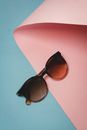 Black Framed Sunglasses on Pink Table