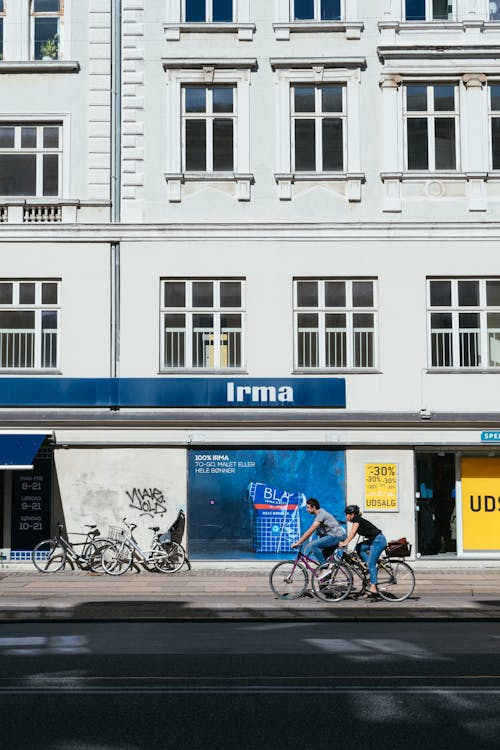 Man and Woman Riding Bicycle on the Street