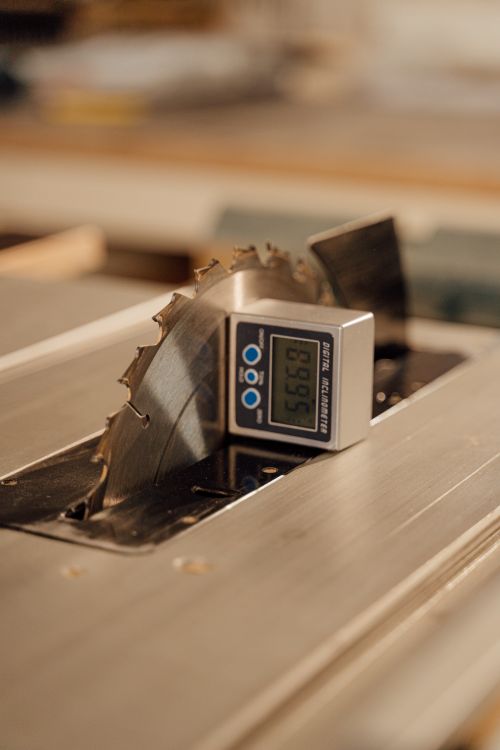 Free Close-up of a circular saw blade with a digital angle gauge displaying a measurement. Ideal for construction themes. Stock Photo
