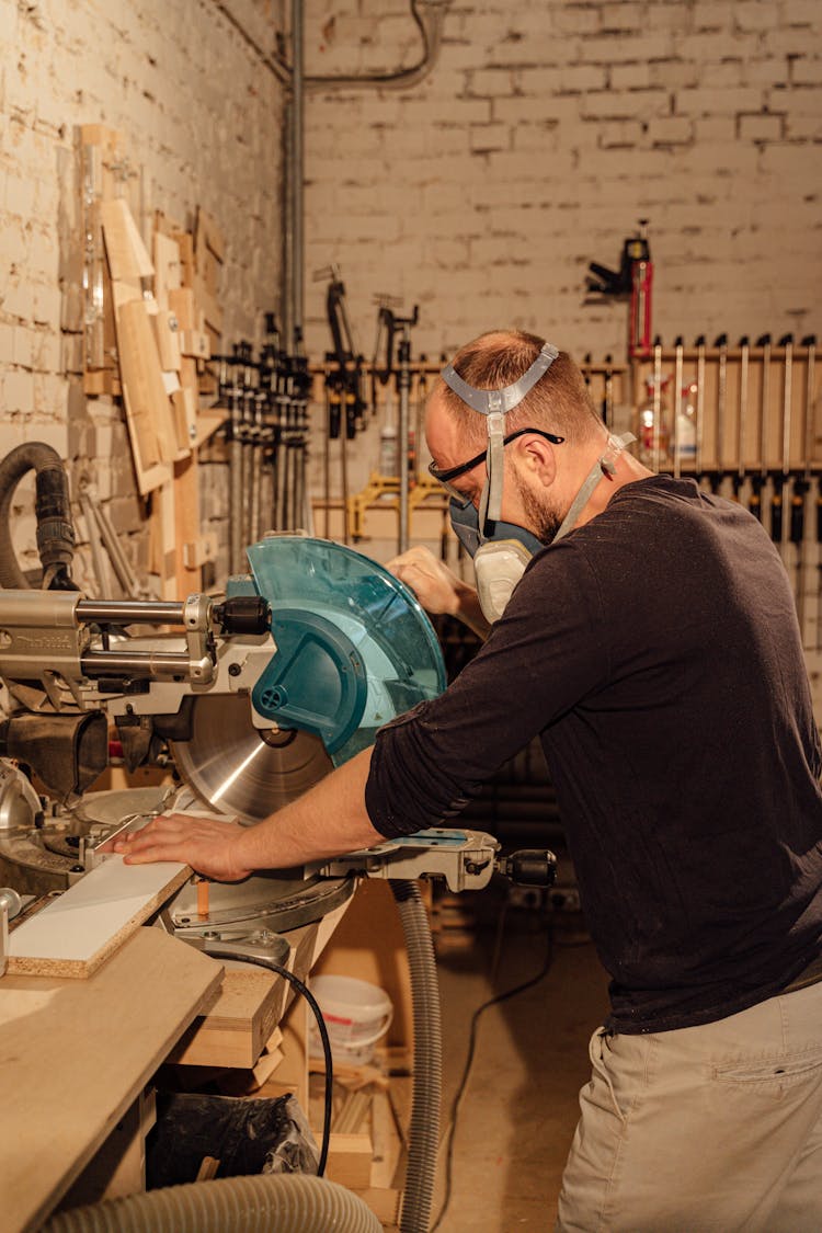 Woodworker Using An Industrial Grinding Machine 