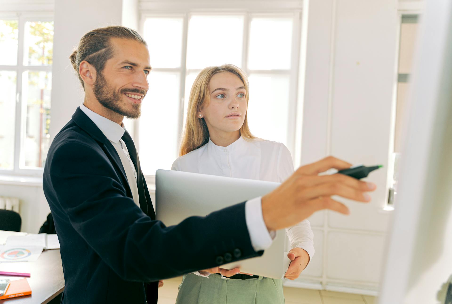 Business professionals collaborating and discussing strategy in a modern office environment.