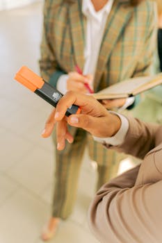 Close-up of business professionals using a highlighter during a meeting.