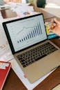 A close-up view of a laptop displaying business analytics and revenue charts.