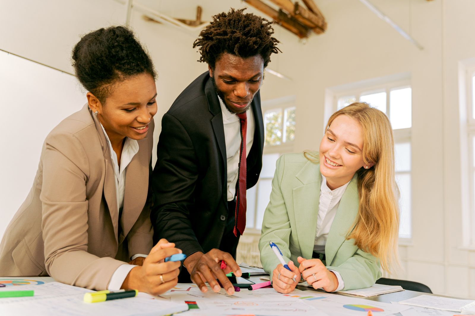 A diverse team collaborating around a table in a supportive work setting