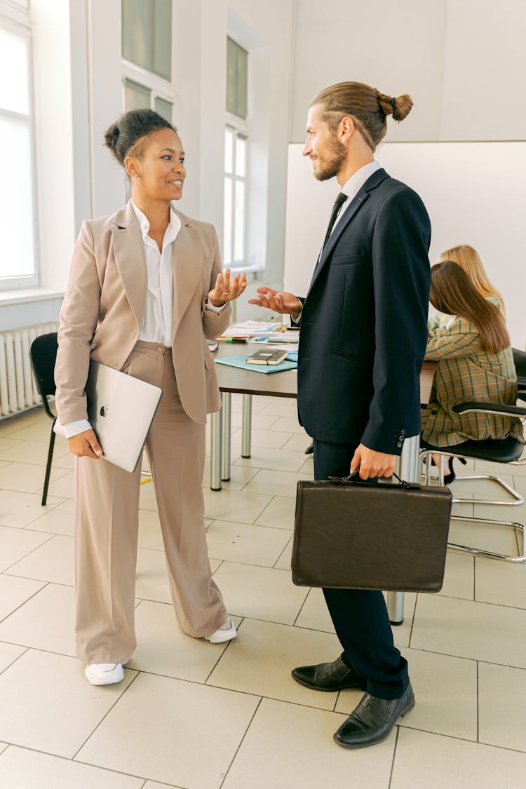 A Businessman And Businesswoman Talking Together