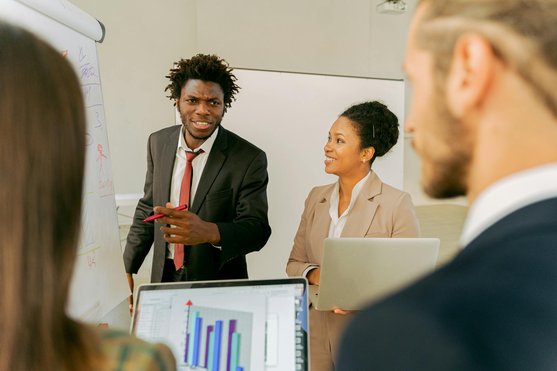 Diverse business team discussing strategies and ideas in a professional office setting.