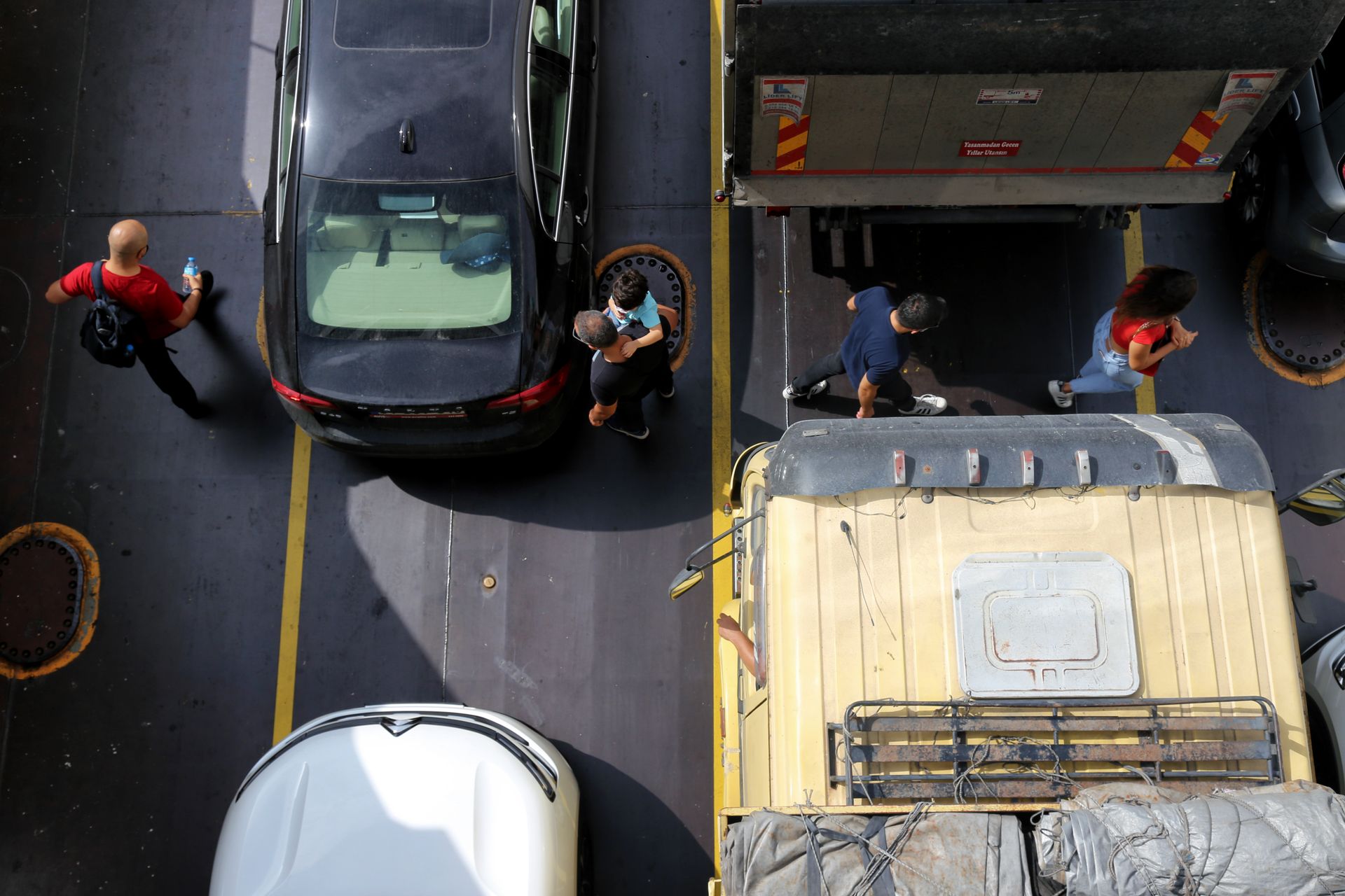Top View Shot of People Crossing the Road Between Vehicles